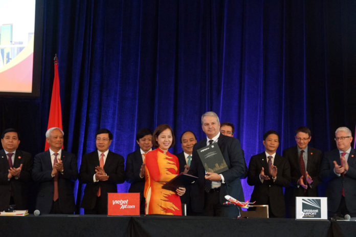 Madam Binh Nguyen, Vice President Vietjet Air, shakes hands with Andrew Brodie, GM Airline and Commercial Businesses Brisbane Airport Corporation, following the signing of a MOU yesterday.