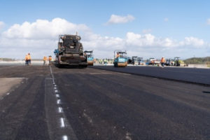 Equipment being used to add the final layer of runway pavement